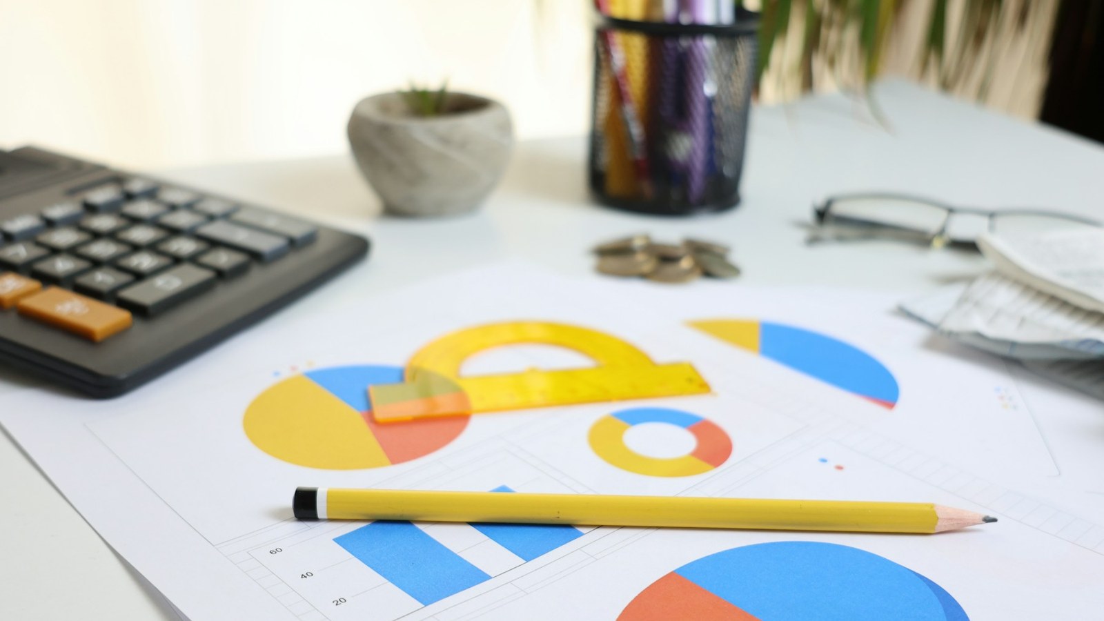 Calculator and printed charts used for book printing cost per copy planning